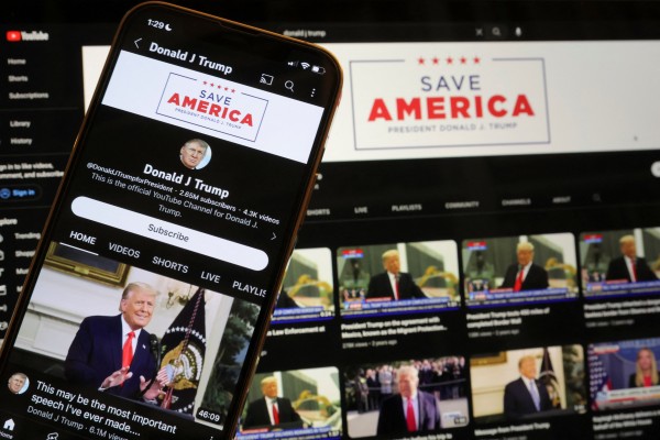 Donald Trump’s YouTube account is seen on a mobile phone and laptop in 2023 after being restored after Google lifted a suspension imposed on Trump after the January 6, 2021 Capitol riot. Photo: Reuters