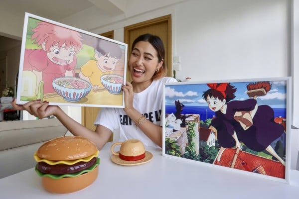 Lukian Wang holds a picture of a scene from Studio Ghibli’s 2008 anime Ponyo at her home in Tsim Sha Tsui, Hong Kong. Her first viral video was of her making instant noodles inspired by food in the film. Photo: Jonathan Wong Lukian Wang holds a picture of a scene from Studio Ghibli’s 2008 anime Ponyo at her home in Tsim Sha Tsui, Hong Kong. Her first viral video was of her making instant noodles inspired by food in the film. Photo: Jonathan Wong