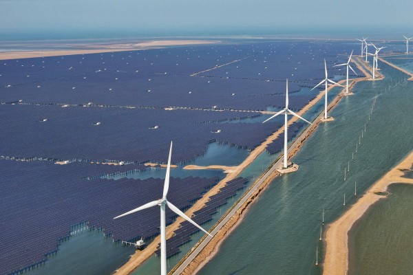 Solar panels and wind turbines are seen at the Huaneng Binzhou new energy power generation project in Binzhou, in China’s eastern Shandong province, on June 11, 2025. Photo: AFP