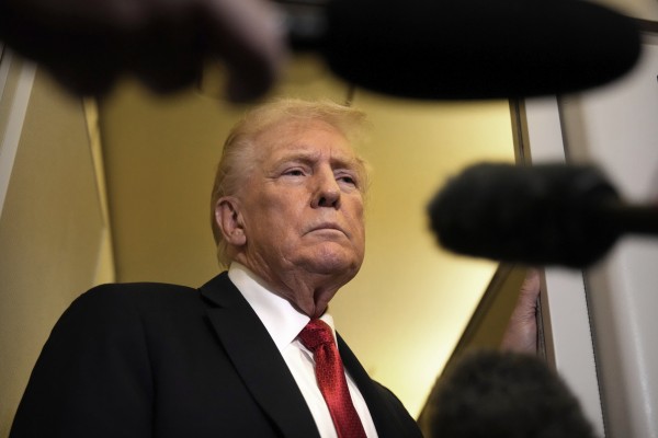 US President Donald Trump speaks to reporters aboard Air Force One. The United States’ decision to widen its trade blacklists in late September may have sparked the latest escalation in the US-China trade war, analysts say. Photo: AP