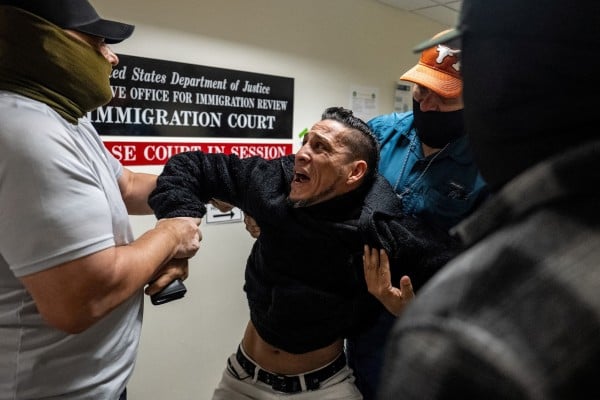 ICE agents and federal officers detain a migrant as he walks out from a hearing during targeted detainment at a US immigration court in New York City. Photo: Reuters ICE agents and federal officers detain a migrant as he walks out from a hearing during targeted detainment at a US immigration court in New York City. Photo: Reuters