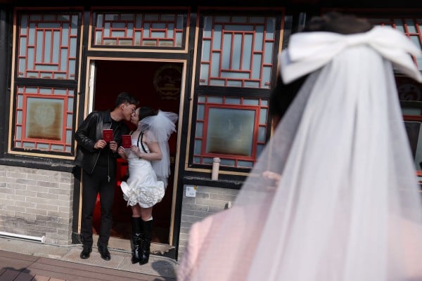 A newlywed couple pose with their marriage certificates after they register at the Huguo Guanyin Temple, in Beijing, China, on October 28, 2025. Photo: Reuters A newlywed couple pose with their marriage certificates after they register at the Huguo Guanyin Temple, in Beijing, China, on October 28, 2025. Photo: Reuters