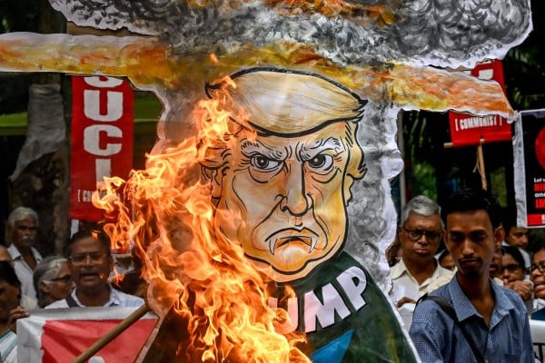 Socialist Unity Centre of India activists burn an effigy of US President Donald Trump at a rally to mark the 80th anniversary of the world’s first atomic bomb attack, on Hiroshima at the end of WWII, in Kolkata on August 6. Photo: AFP Socialist Unity Centre of India activists burn an effigy of US President Donald Trump at a rally to mark the 80th anniversary of the world’s first atomic bomb attack, on Hiroshima at the end of WWII, in Kolkata on August 6. Photo: AFP