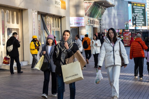 Shoppers walk the streets in Beijing. China projects its middle-income population will reach 800 million within the next 10 years. Photo: EPA-EFE Shoppers walk the streets in Beijing. China projects its middle-income population will reach 800 million within the next 10 years. Photo: EPA-EFE