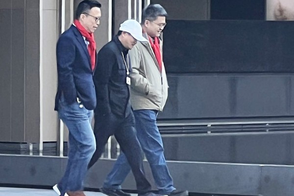 Jack Ma, wearing a white cap, walks alongside Ant Group chairman Eric Jing Xiandong (left) and CEO Cyril Han Xinyi at the fintech giant’s campus in Hangzhou. Photo: Handout
