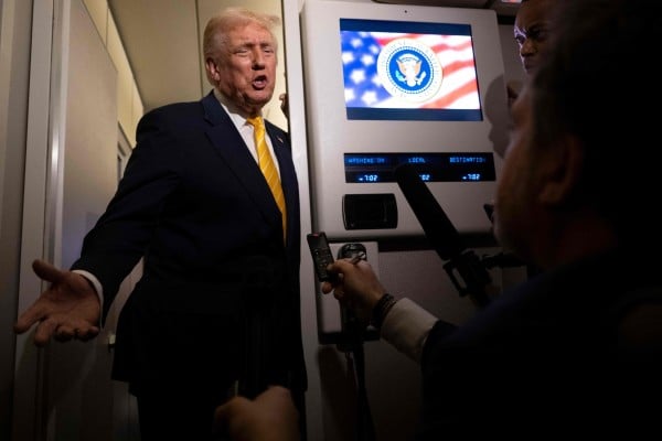 US President Donald Trump speaks to reporters on board Air Force One on Friday while in flight from Washington to West Palm Beach International Airport. Photo: Getty Images via AFP US President Donald Trump speaks to reporters on board Air Force One on Friday while in flight from Washington to West Palm Beach International Airport. Photo: Getty Images via AFP