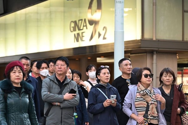 Members of a Chinese tour group wait to cross a road in Tokyo’s Ginza shopping district on Monday. Photo: AFP Members of a Chinese tour group wait to cross a road in Tokyo’s Ginza shopping district on Monday. Photo: AFP
