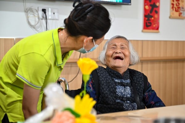 An elderly person chats with a staff worker at an aged-care service centre in China’s Hainan province last month. Photo: Xinhua An elderly person chats with a staff worker at an aged-care service centre in China’s Hainan province last month. Photo: Xinhua