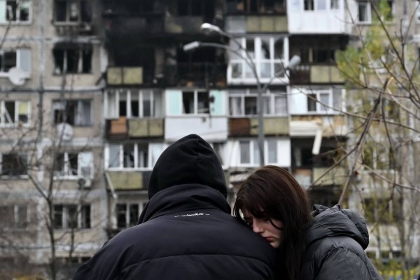 Residents react on Saturday in front of a damaged apartment building following another fatal Russian attack on Kyiv. Photo: AFP
