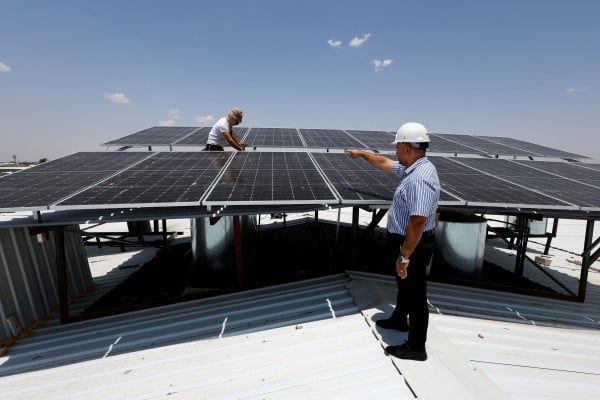 Workers inspect solar panels, an increasingly popular sustainable energy option for homes and businesses to generate electricity, in Mosul, Iraq, on July 9. Photo: Reuters Workers inspect solar panels, an increasingly popular sustainable energy option for homes and businesses to generate electricity, in Mosul, Iraq, on July 9. Photo: Reuters