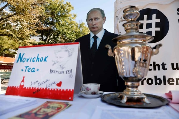 A mock offer of “Novichok Tea” sits in front of an effigy of Russian President Vladimir Putin outside the Russian embassy in Berlin in 2020. Photo: AFP A mock offer of “Novichok Tea” sits in front of an effigy of Russian President Vladimir Putin outside the Russian embassy in Berlin in 2020. Photo: AFP
