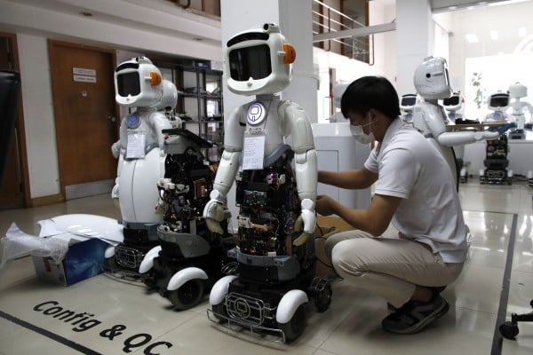 A Thai engineer services AI-powered healthcare robots in Bangkok, Thailand, in 2023. Photo: EPA-EFE A Thai engineer services AI-powered healthcare robots in Bangkok, Thailand, in 2023. Photo: EPA-EFE