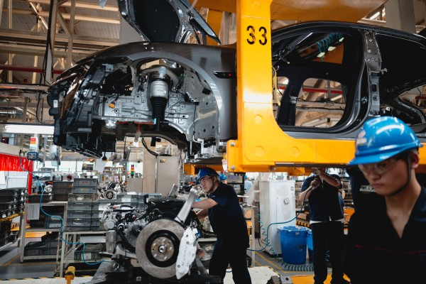 Labourers work on an assembly line at a factory in Chongqing, China, in May. Beijing has pressed German carmakers to help resolve disputes over the European Union’s anti-subsidy tariffs on Chinese electric vehicles. Photo: EPA-EFE