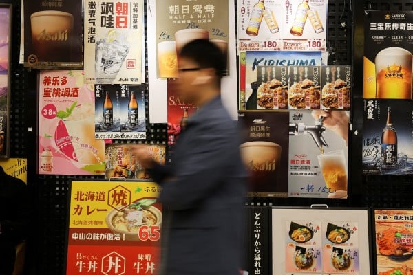 A man walks past posters advertising Japanese restaurants at a shopping mall in Shanghai. Tensions between China and Japan remain high amid a dispute over Taiwan. Photo: Reuters A man walks past posters advertising Japanese restaurants at a shopping mall in Shanghai. Tensions between China and Japan remain high amid a dispute over Taiwan. Photo: Reuters