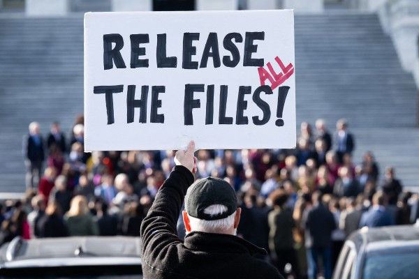 A protester holds a sign related to the release of the Jeffrey Epstein case files outside the US Capitol in Washington last month. Photo: TNS A protester holds a sign related to the release of the Jeffrey Epstein case files outside the US Capitol in Washington last month. Photo: TNS