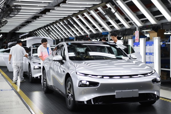 Workers conduct final checks on an Xpeng new energy car at the firm’s plant in Zhaoqing,  Guangdong province, on October 9, 2023. Photo: Xinhua 