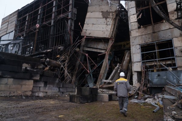 A Ukrainian power plant worker walks in front of a damaged production hall after a Russian missile attack this month. Photo: AP A Ukrainian power plant worker walks in front of a damaged production hall after a Russian missile attack this month. Photo: AP