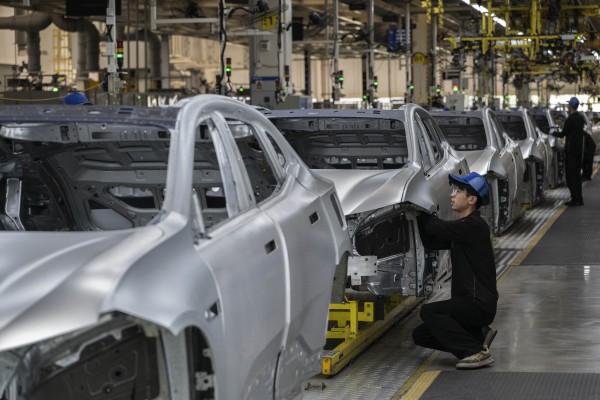 A worker checks the frame of a car on a production line under Geely Auto’s Zeekr brand in Ningbo. Photo: Getty Images