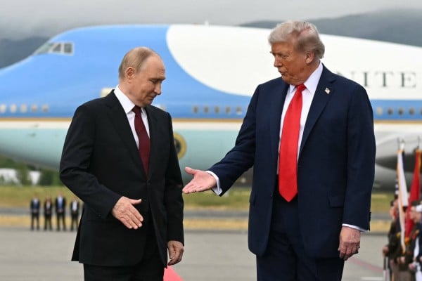 US President Donald Trump (right) reaches out to shake hands with Russian President Vladimir Putin on the tarmac at a military base in Anchorage, Alaska in August. Photo: AFP US President Donald Trump (right) reaches out to shake hands with Russian President Vladimir Putin on the tarmac at a military base in Anchorage, Alaska in August. Photo: AFP