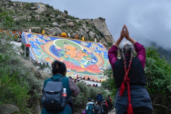 In Lhasa in August, worshippers stand before a huge Thangka painting at the Drepung Monastery for the Shoton Festival. An international symposium on the 6th Dalai Lama organised by India has sparked ire in China. Photo: China News Service/VCG via Getty Images In Lhasa in August, worshippers stand before a huge Thangka painting at the Drepung Monastery for the Shoton Festival. An international symposium on the 6th Dalai Lama organised by India has sparked ire in China. Photo: China News Service/VCG via Getty Images