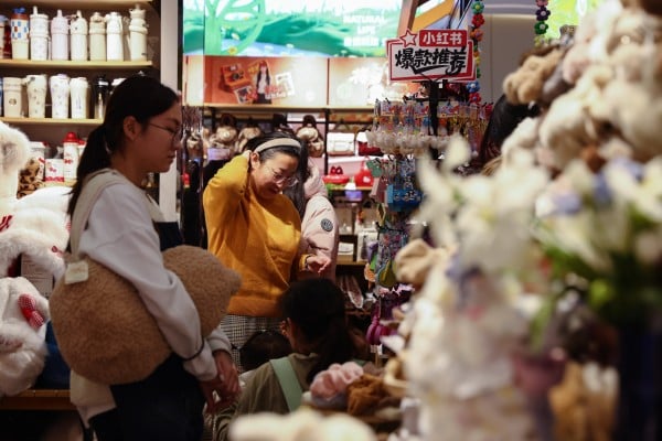 Shoppers browse goods in a gift shop in Beijing, China on December 8. Chinese authorities have highlighted tax policy as a way to support growth amid weak demand. Photo: EPA Shoppers browse goods in a gift shop in Beijing, China on December 8. Chinese authorities have highlighted tax policy as a way to support growth amid weak demand. Photo: EPA