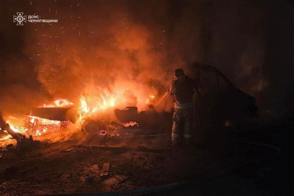 A Ukrainian rescuer in the Chernihiv region works to extinguish a fire following the latest drone strikes by Russia. Photo: Handout via AFP