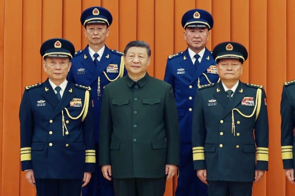 President Xi Jinping (centre), also chairman of the CMC, poses with top military officers at the promotions ceremony in Beijing on Monday. Pictured at the back are newly promoted generals Yang Zhibin (left) and Han Shengyan. Photo: AP President Xi Jinping (centre), also chairman of the CMC, poses with top military officers at the promotions ceremony in Beijing on Monday. Pictured at the back are newly promoted generals Yang Zhibin (left) and Han Shengyan. Photo: AP