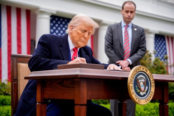 US President Donald Trump signs executive orders at the White House on April 2, 2025, imposing tariffs on imported goods. Photo: Getty Images US President Donald Trump signs executive orders at the White House on April 2, 2025, imposing tariffs on imported goods. Photo: Getty Images