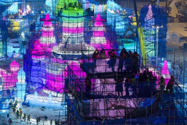 Workers at the construction site for the main tower of Harbin Ice and Snow World in Harbin, China. Photo: Xinhua