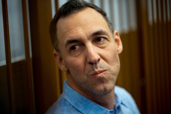 French citizen Laurent Vinatier sits in a cage prior to a court session in Moscow in October 2024. Photo: AP