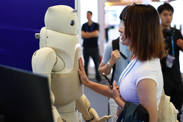 A visitor interacts with a robot at the Pujiang Innovation Forum in  Shanghai on September 21. Photo: Xinhua