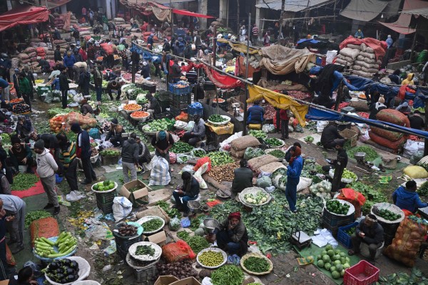 People buy vegetables at a market in the old quarters of New Delhi on Tuesday. Photo: AFP