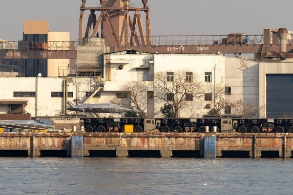Three trucks linked to form what appears to be a launch track for large drones have been spotted at a dock in China. Photo: Handout