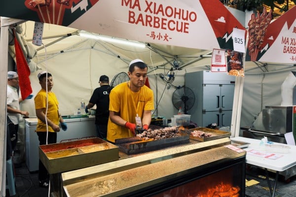 A vendor grills skewered meats at the Pasar Eatai Chinese Muslim Festival at 1 Utama Shopping Centre in Kuala Lumpur on Tuesday. Photo: Iman Muttaqin Yusof A vendor grills skewered meats at the Pasar Eatai Chinese Muslim Festival at 1 Utama Shopping Centre in Kuala Lumpur on Tuesday. Photo: Iman Muttaqin Yusof