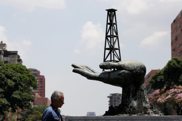 A man walks past a sculpture outside a building of Venezuela’s state oil company PDVSA in Caracas, Venezuela, on May 17, 2019. Photo: Reuters