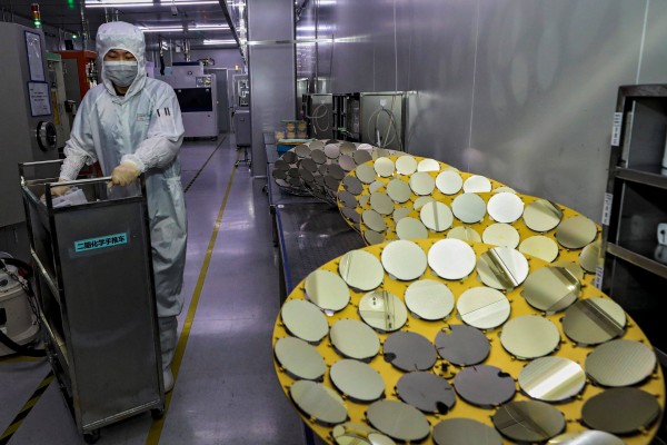 A worker is seen at a semiconductor factory in China’s Jiangsu province. Beijing has launched an anti-dumping investigation against Japan over a chemical used in chipmaking. Photo: AFP
