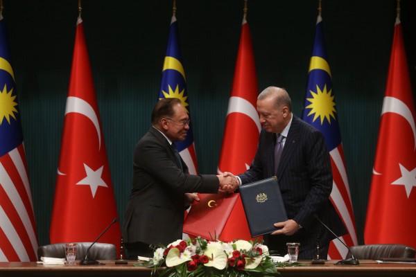 Turkish President Recep Tayyip Erdogan (right) and Malaysian Prime Minister Anwar Ibrahim exchange a signed agreement in Ankara on Wednesday. Photo: Turkish Presidency/Xinhua