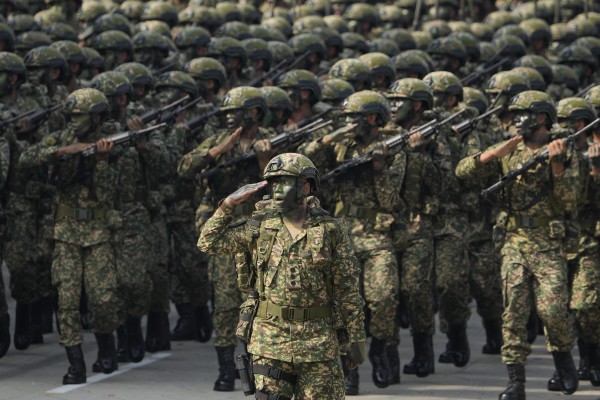 Malaysian army troops march in formation for National Day celebrations.  Photo: AP