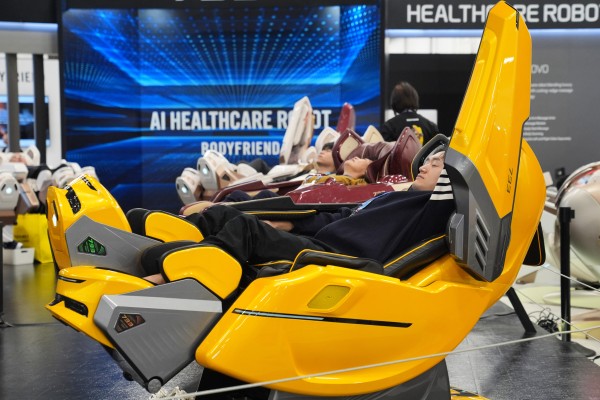 People try out the Bodyfriend 733 Healthcare Robot at the CES trade show in Las Vegas on January 6, 2026. Photo: AP