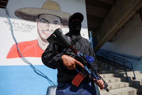 A member of “3 Raices”’ a pro-government group known as “colectivos”, stands guard with an assault rifle at the organisation’s headquarters in the working-class neighbourhood of 23 de Enero, in Caracas, Venezuela, on Wednesday. Photo: AFP A member of “3 Raices”’ a pro-government group known as “colectivos”, stands guard with an assault rifle at the organisation’s headquarters in the working-class neighbourhood of 23 de Enero, in Caracas, Venezuela, on Wednesday. Photo: AFP