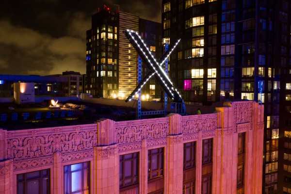 Workers install lighting on an ‘X’ sign atop the company headquarters, formerly known as Twitter, in downtown San Francisco in 2023. Photo: AP