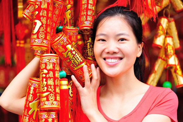 A woman holds Lunar New Year decorations. Throughout China, greetings in various dialects will be exchanged to welcome the Year of the Horse. Here are some of them and their meanings. Photo: Shutterstock