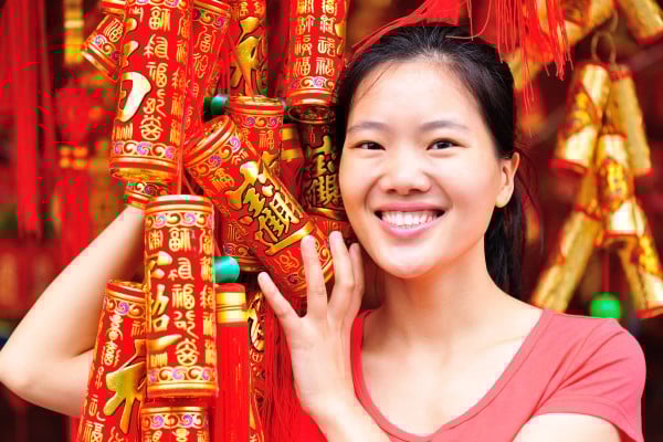 A woman holds Lunar New Year decorations. Throughout China, greetings in various dialects will be exchanged to welcome the Year of the Horse. Here are some of them and their meanings. Photo: Shutterstock A woman holds Lunar New Year decorations. Throughout China, greetings in various dialects will be exchanged to welcome the Year of the Horse. Here are some of them and their meanings. Photo: Shutterstock