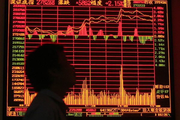 A Chinese trader looks at an electronic trading board at the Shanghai stock exchange. Photo: Reuters