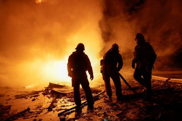 Firefighters work at a private delivery company’s logistics hub hit by a Russian missile strike in Kharkiv, Ukraine on Tuesday. Photo: Reuters Firefighters work at a private delivery company’s logistics hub hit by a Russian missile strike in Kharkiv, Ukraine on Tuesday. Photo: Reuters