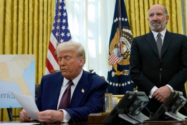 US Commerce Secretary Howard Lutnick (right) and US President Donald Trump are seen last year in the Oval Office of the White House. Photo: AP