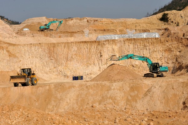 Workers use machinery to dig at a rare earth mine in Ganxian county in central China’s Jiangxi province. Photo: Chinatopix via AP