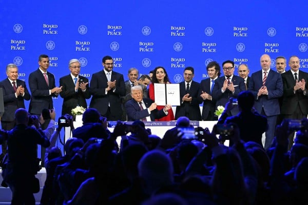 US President Donald Trump holding a signed founding charter with leaders and representatives from other countries. Photo: AFP US President Donald Trump holding a signed founding charter with leaders and representatives from other countries. Photo: AFP