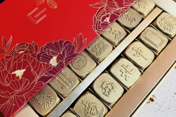 A box of Conspiracy Chocolate’s latest Lunar New Year collection showcases “mahjong tiles” displayed in a winning “13 Orphans” hand. The chocolate set has sparked a cultural appropriation debate over its unlucky symbolism. Photo: Conspiracy Chocolate