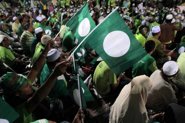 Supporters of the Pan-Malaysian Islamic Party (PAS) wave flags during a rally in Kedah in 2012. Photo: AFP